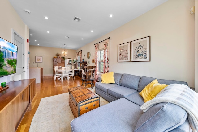 390 1st St Unit 3, Jersey City, NJ 07302 - living room with light wood-style floors, a chandelier, and recessed lighting