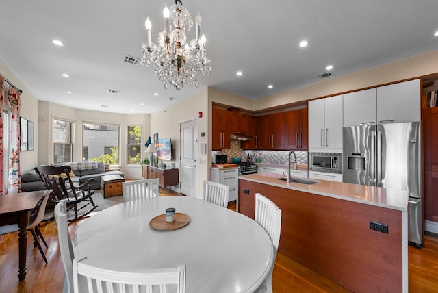 390 1st St Unit 3, Jersey City, NJ 07302 - dining room featuring wood finished floors, recessed lighting, and a chandelier