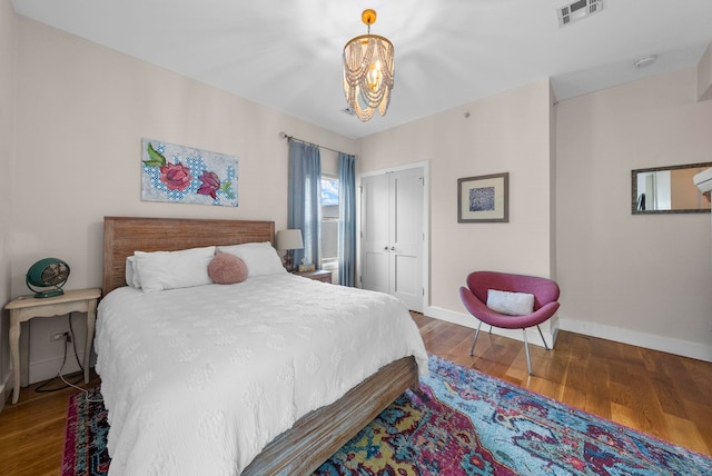 390 1st St Unit 3, Jersey City, NJ 07302 - bedroom featuring a chandelier, wood finished floors, and a closet
