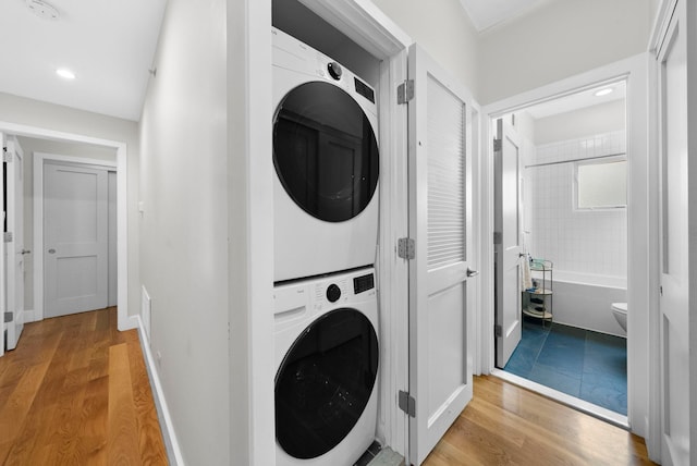 390 1st St Unit 3, Jersey City, NJ 07302 - laundry room with stacked washer / dryer, light wood-style floors, and recessed lighting