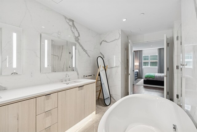 800 Ave At Port Imperial Unit 517, Weehawken, NJ 07086 - bathroom featuring ensuite bath, a freestanding bath, vanity, and a marble finish shower