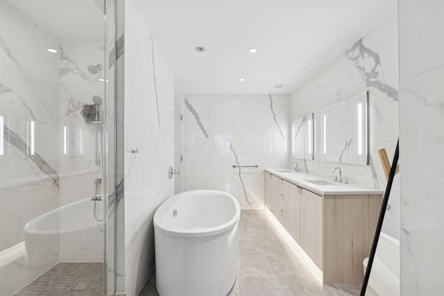 800 Ave At Port Imperial Unit 517, Weehawken, NJ 07086 - full bathroom with double vanity, a soaking tub, tile walls, a marble finish shower, and recessed lighting