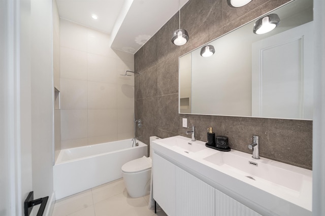 full bathroom with shower / tub combination, tile walls, tile patterned flooring, vanity, and toilet