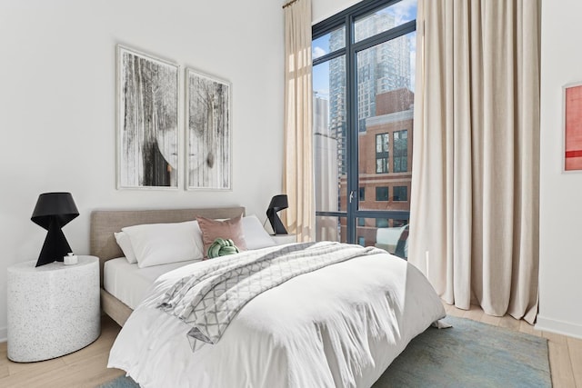 bedroom with wood finished floors and baseboards