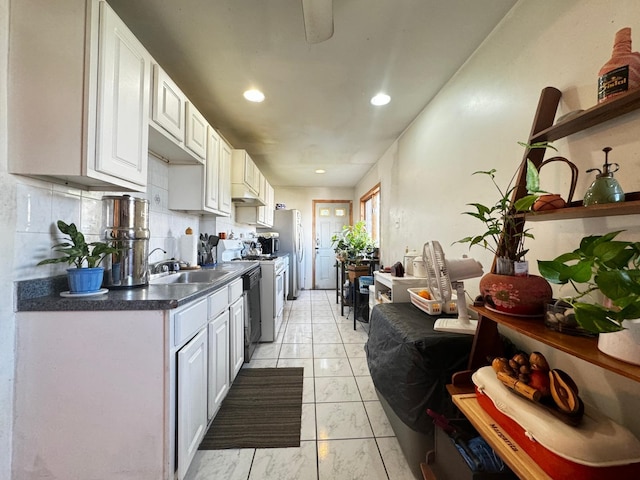 kitchen with white cabinetry, sink, appliances with stainless steel finishes, and tasteful backsplash