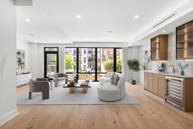 906 Park Ave Unit 1, Hoboken, NJ 07030 - living room featuring beverage cooler, wet bar, light wood-style floors, baseboards, and recessed lighting