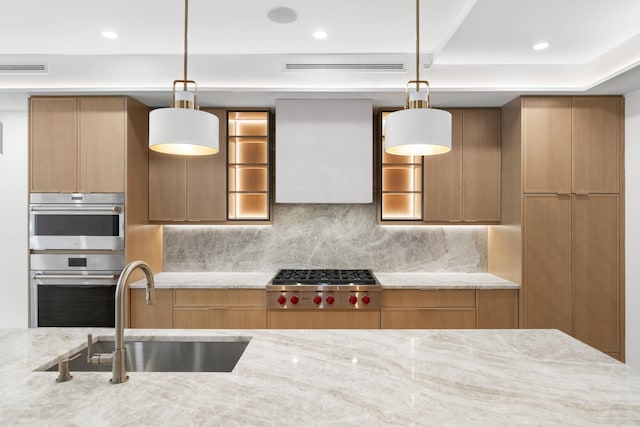 906 Park Ave Unit 1, Hoboken, NJ 07030 - kitchen featuring a sink, appliances with stainless steel finishes, light stone countertops, decorative backsplash, and pendant lighting