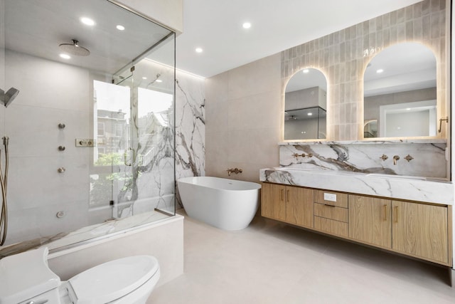 906 Park Ave Unit 1, Hoboken, NJ 07030 - full bathroom featuring tile walls, a marble finish shower, vanity, a soaking tub, and toilet
