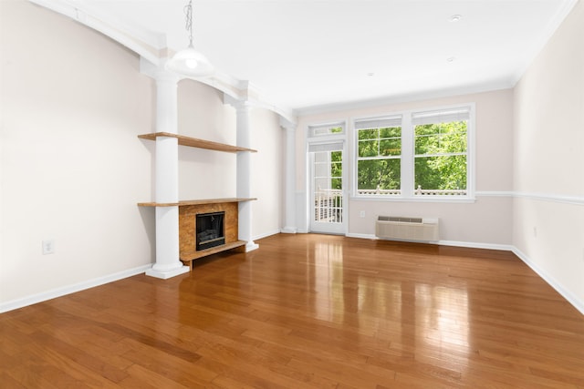 15 Freedom Way Unit 212, Jersey City, NJ 07305 - unfurnished living room featuring an AC wall unit, wood finished floors, a fireplace, and ornamental molding