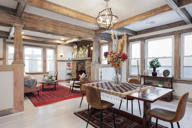 dining area featuring a fireplace, light hardwood / wood-style floors, and plenty of natural light