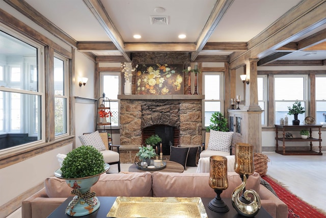 carpeted living room featuring beamed ceiling, plenty of natural light, and a fireplace