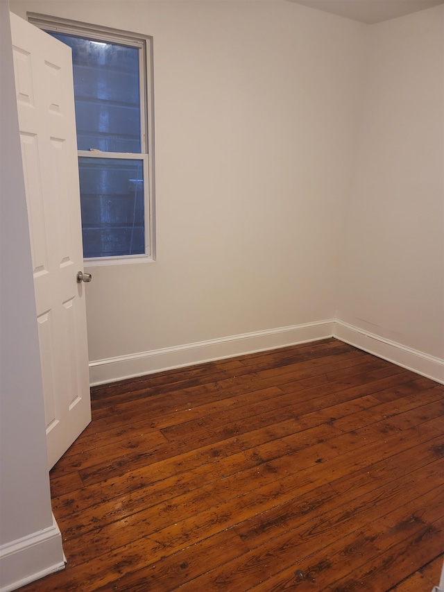 unfurnished room featuring dark hardwood / wood-style flooring