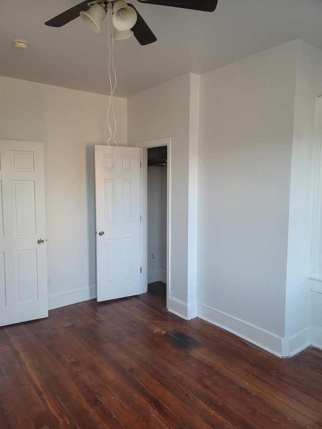 unfurnished bedroom with dark hardwood / wood-style floors and ceiling fan