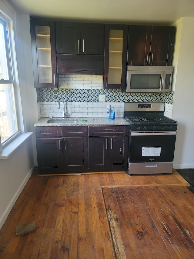 kitchen with hardwood / wood-style flooring, a healthy amount of sunlight, sink, and stainless steel appliances