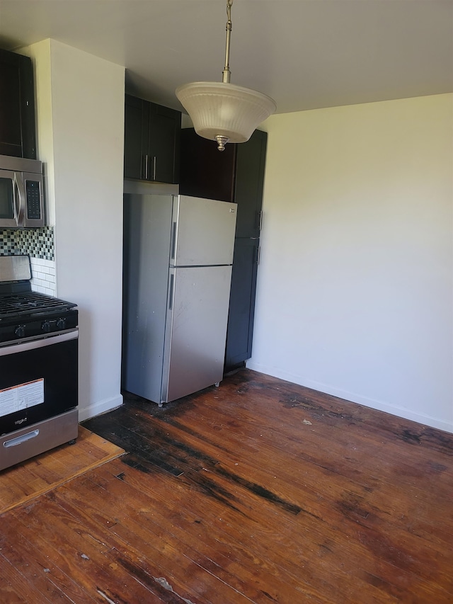 kitchen with backsplash, dark hardwood / wood-style flooring, stainless steel appliances, and decorative light fixtures