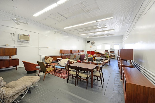 dining space featuring an AC wall unit and ceiling fan