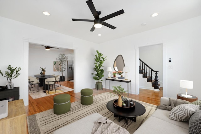 living room with wood-type flooring and ceiling fan