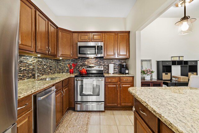 264 9th St Unit 3C, Jersey City, NJ 07302 - kitchen featuring appliances with stainless steel finishes, tasteful backsplash, light stone counters, and light tile patterned floors