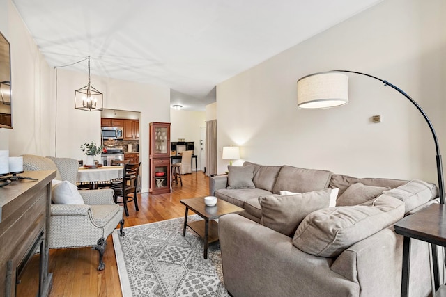 264 9th St Unit 3C, Jersey City, NJ 07302 - living area featuring light wood-type flooring and a chandelier