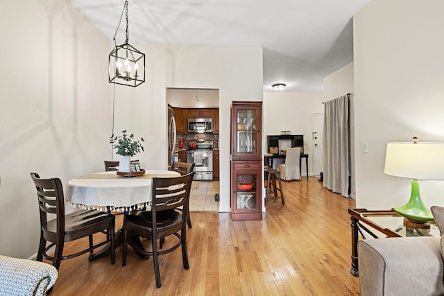 264 9th St Unit 3C, Jersey City, NJ 07302 - dining space with light wood-style flooring and a chandelier