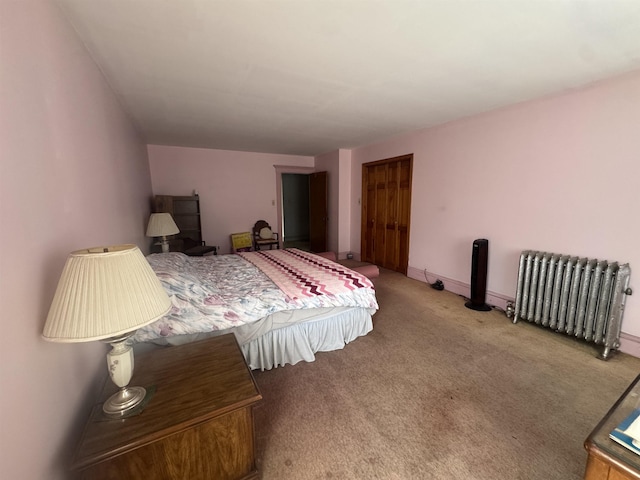 bedroom with baseboards, carpet flooring, and radiator