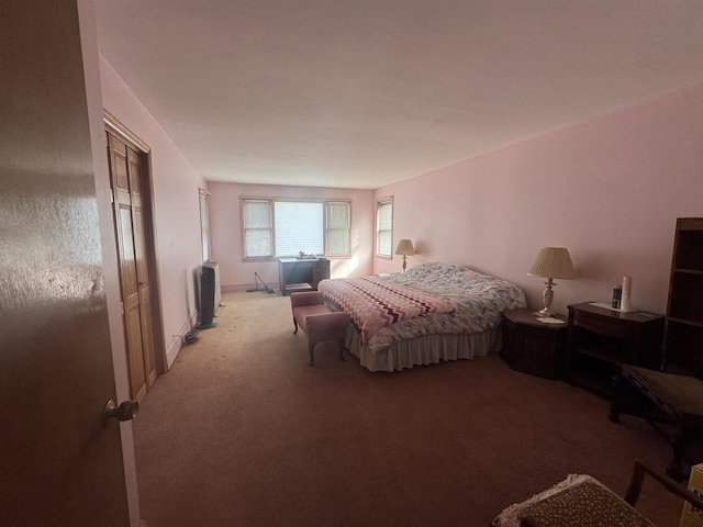 bedroom featuring baseboards and carpet flooring