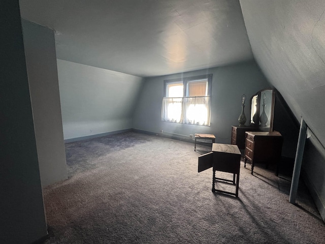 additional living space featuring carpet floors, lofted ceiling, and baseboards