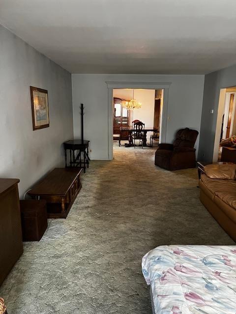 40 E 31st St, Bayonne, NJ 07002 - carpeted living area featuring a chandelier