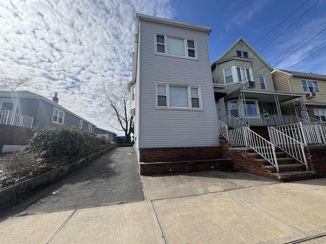 multi unit property featuring a porch and stairs