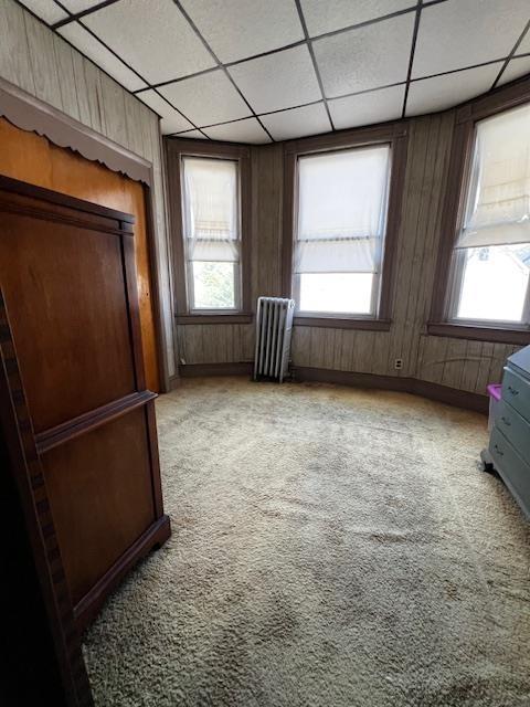 40 E 31st St, Bayonne, NJ 07002 - bedroom featuring radiator, light colored carpet, and a paneled ceiling