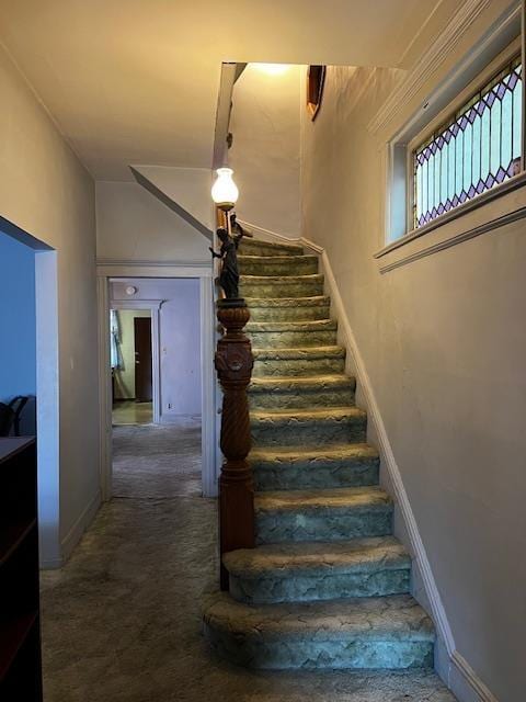 40 E 31st St, Bayonne, NJ 07002 - staircase featuring carpet floors and baseboards