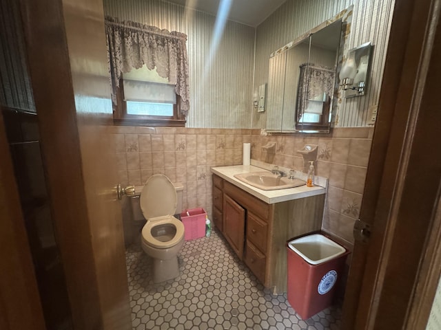 40 E 31st St, Bayonne, NJ 07002 - half bath featuring toilet, vanity, tile walls, and wainscoting
