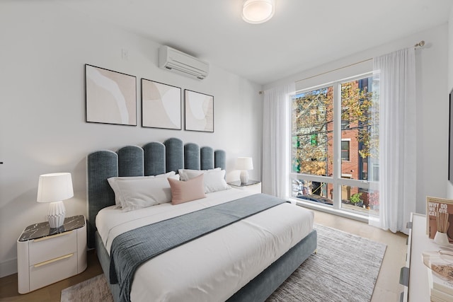 391 1st St Unit 2-C, Jersey City, NJ 07302 - bedroom with an AC wall unit and wood finished floors