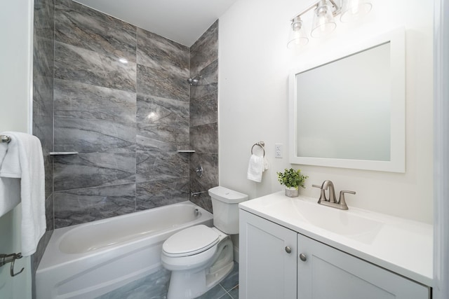 full bathroom featuring vanity, tile patterned floors, tiled shower / bath, and toilet