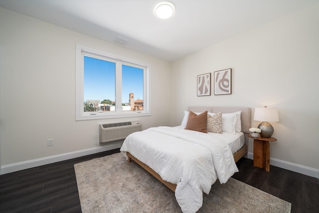 bedroom featuring a wall mounted AC and dark hardwood / wood-style flooring