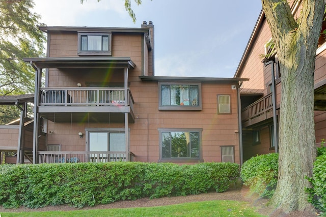 98 Sandpiper Ky, Secaucus, NJ 07094 - rear view of house with a balcony and a chimney