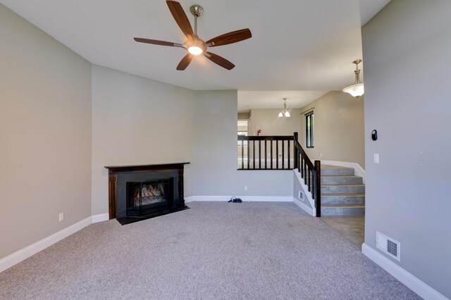 98 Sandpiper Ky, Secaucus, NJ 07094 - unfurnished living room featuring carpet, a ceiling fan, a fireplace with flush hearth, and stairway