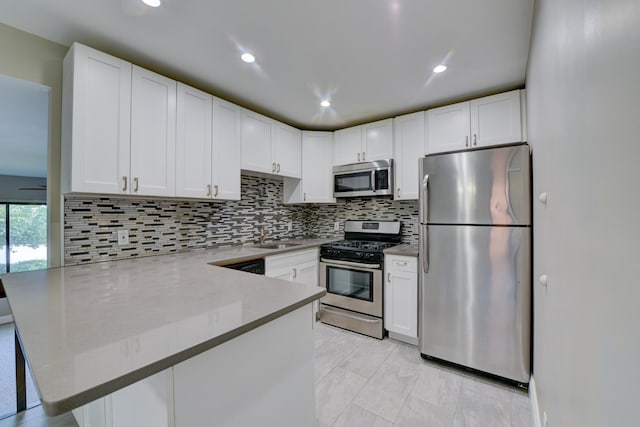 98 Sandpiper Ky, Secaucus, NJ 07094 - kitchen featuring stainless steel appliances, a peninsula, white cabinetry, and recessed lighting