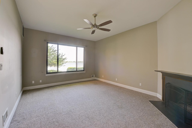 98 Sandpiper Ky, Secaucus, NJ 07094 - unfurnished living room with carpet flooring, a ceiling fan, and a fireplace with flush hearth