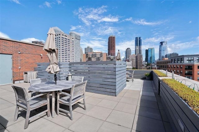 view of patio / terrace with a city view and outdoor dining space