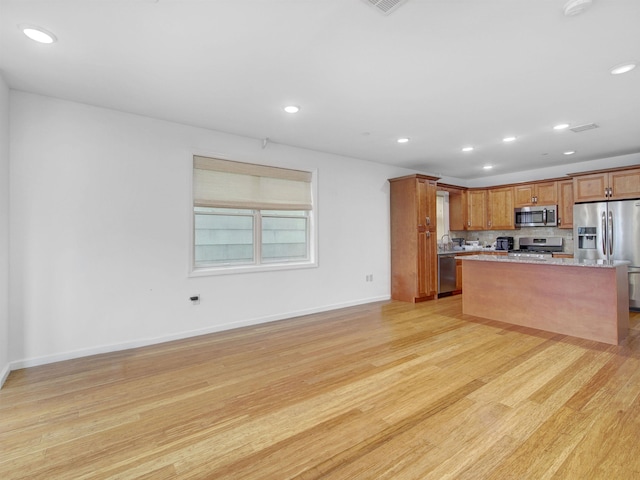 517 19th St # 2, Union City, NJ 07087 - kitchen with stainless steel appliances, recessed lighting, light wood finished floors, brown cabinetry, and a center island