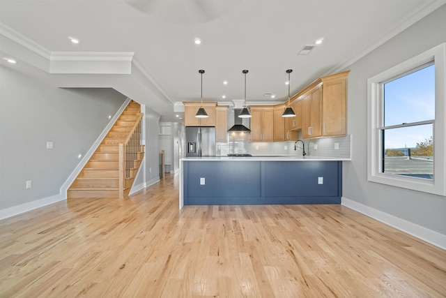 kitchen with wall chimney exhaust hood, stainless steel fridge with ice dispenser, decorative light fixtures, decorative backsplash, and ornamental molding