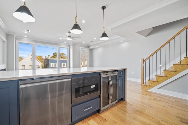 kitchen featuring refrigerator, crown molding, wine cooler, built in microwave, and decorative light fixtures