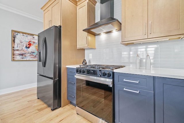 kitchen with gray cabinetry, crown molding, wall chimney range hood, fridge with ice dispenser, and stainless steel stove