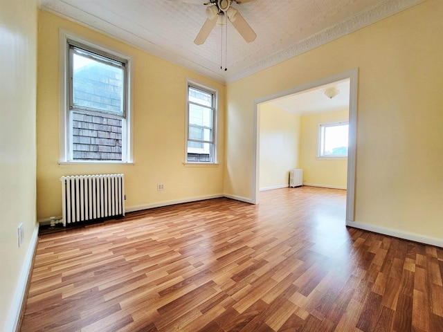 1214 79th St, North Bergen, NJ 07047 - unfurnished room featuring radiator, light wood-style flooring, radiator heating unit, and ceiling fan