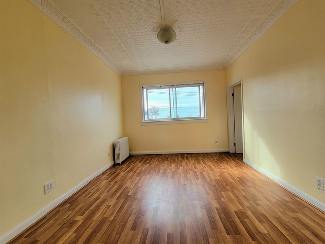 1214 79th St, North Bergen, NJ 07047 - empty room featuring radiator, wood finished floors, and ornamental molding