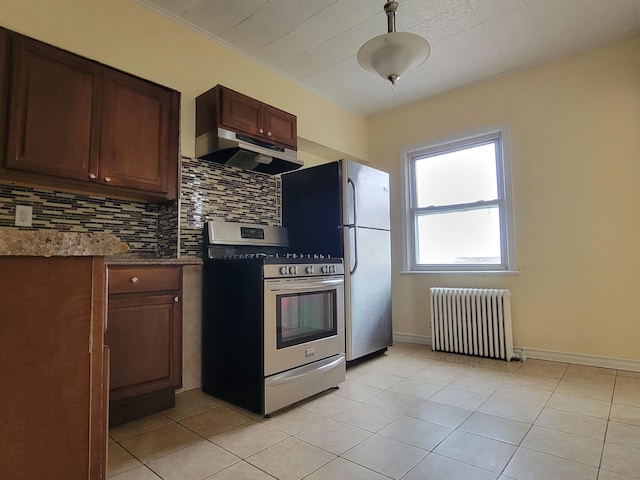 1214 79th St, North Bergen, NJ 07047 - kitchen featuring radiator heating unit, appliances with stainless steel finishes, under cabinet range hood, backsplash, and light tile patterned floors