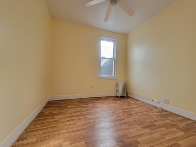 1214 79th St, North Bergen, NJ 07047 - empty room with radiator, ceiling fan, light wood-type flooring, and vaulted ceiling
