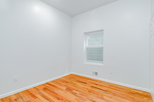 spare room featuring visible vents, baseboards, and light wood-style flooring