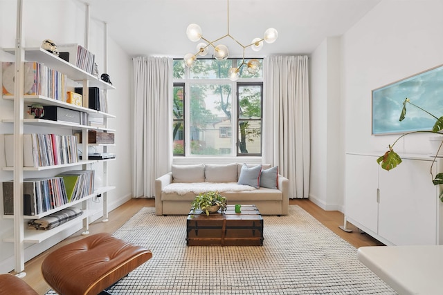 120 Sherman Ave Unit 2B, Jersey City, NJ 07307 - living area with a chandelier, light wood-style floors, and baseboards